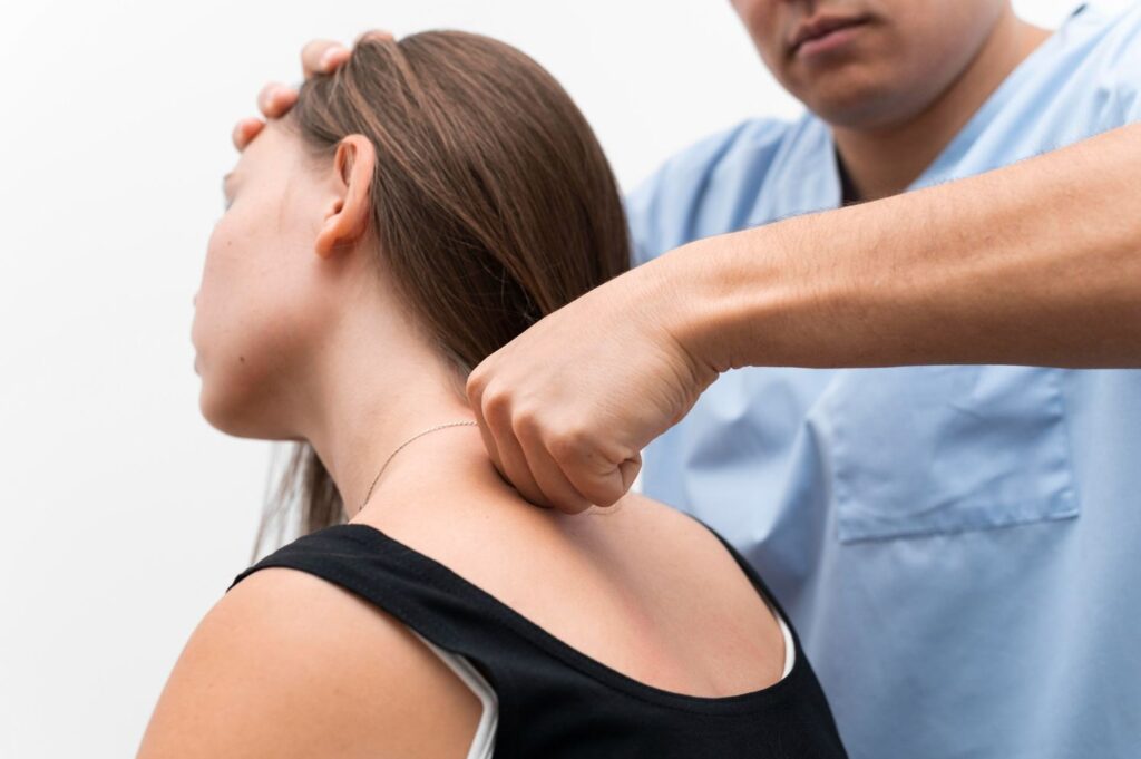 A chiropractor performs a cervical adjustment on a female patient to address neck pain.
