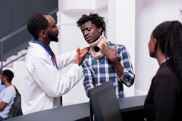 Physician consulting a patient wearing a cervical neck collar.