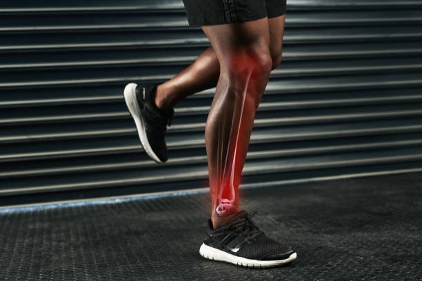 man's leg with a red glow indicating joint pain or injury.